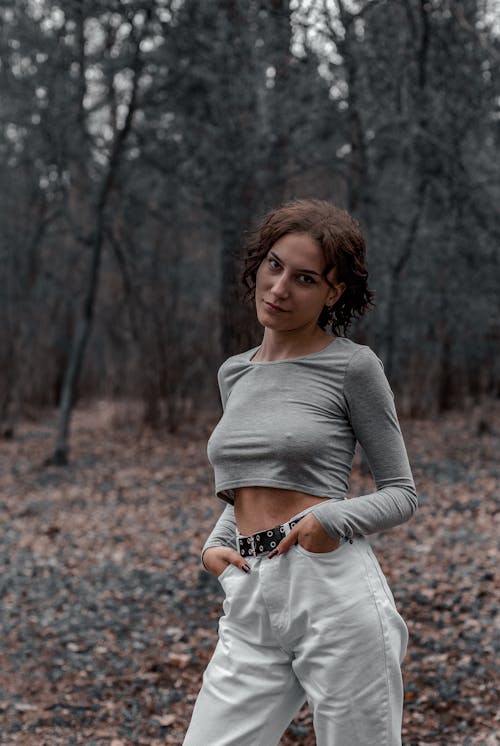 Woman in Gray Long Sleeve Shirt and White Pants