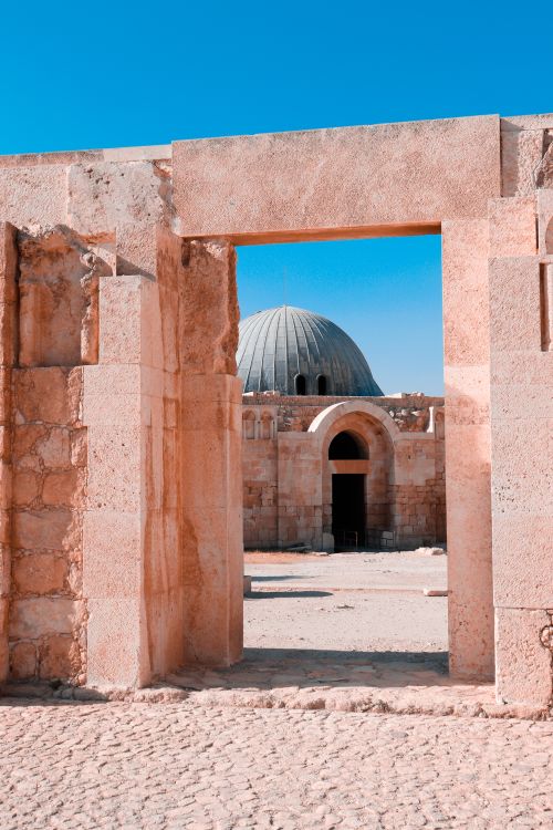 Free View of the historic Umayyad Palace through stone entrance in Amman, Jordan. Stock Photo