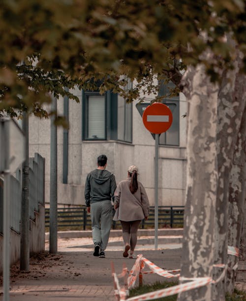 Free Back View of a Couple Walking Together Stock Photo