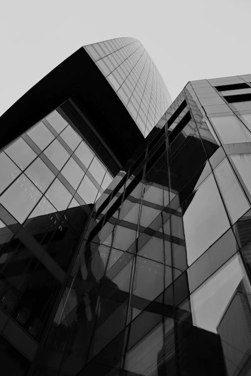Grayscale Photo of Glass Building