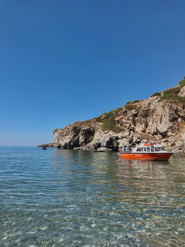 Boat In The Sea With Rocky Seabed 