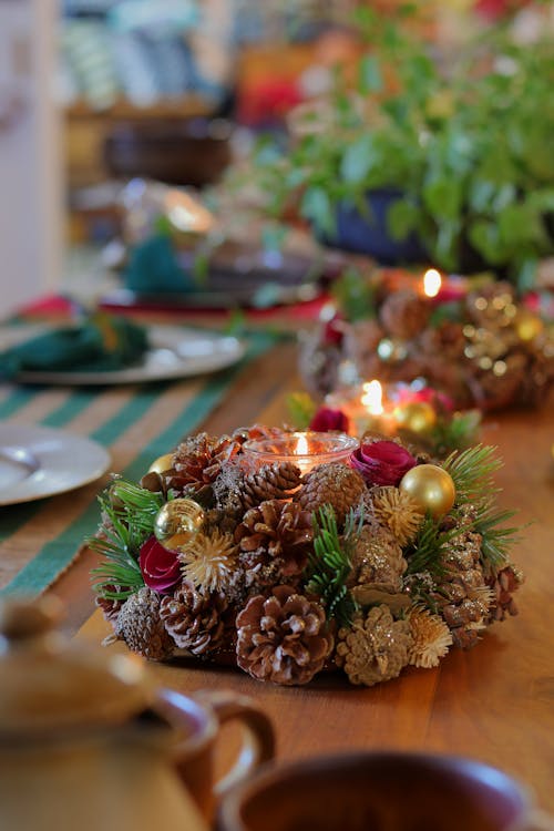 Lighted Candles on Christmas Decoration on a Wooden Surface