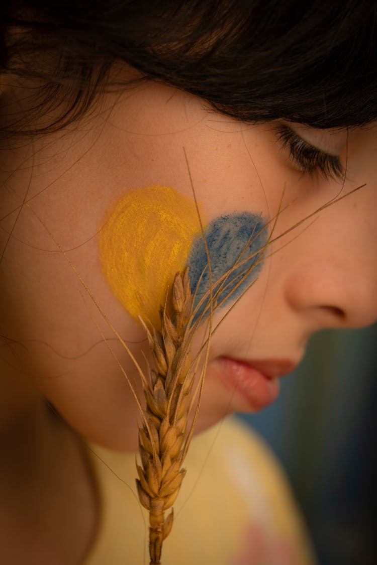 Woman With Yellow And Blue Heart On Face