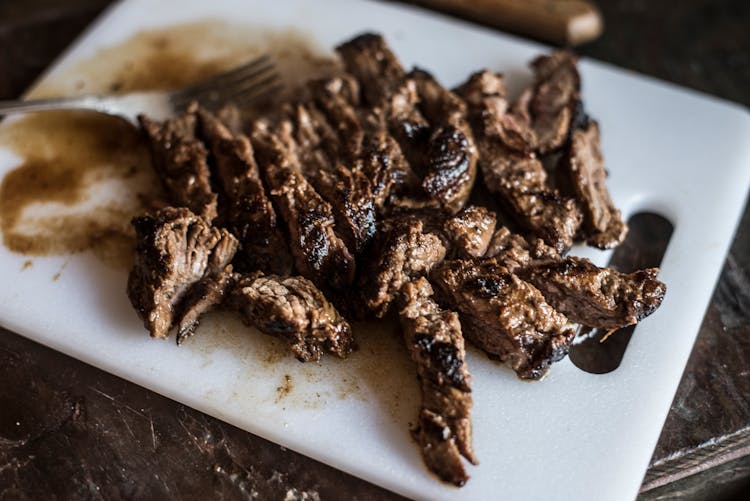 Marinated Steak Bites On White Platter In Close Up Photography