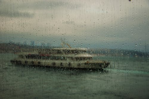 Free Blurred View of Boat on Sea on a Rainy Day Through a Window Stock Photo