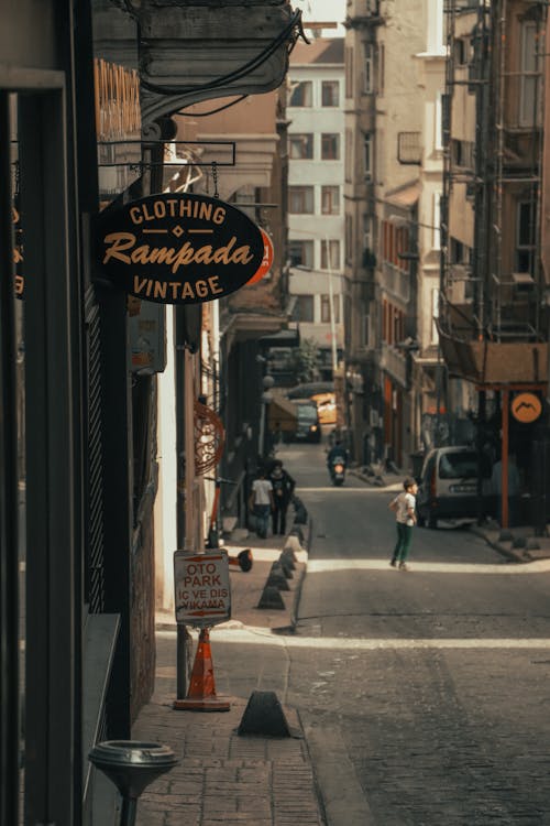 People Standing on the Street Between Business Establihsment