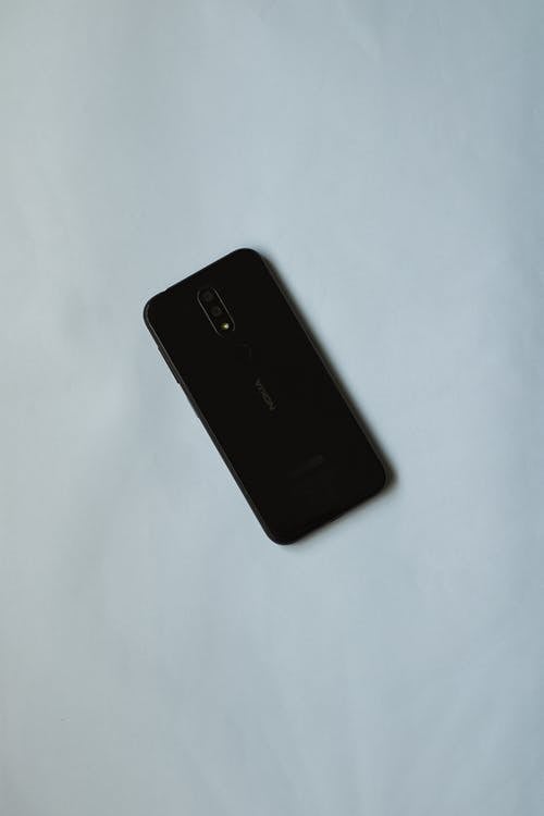 Smartphone with Black Screen on Blue Background