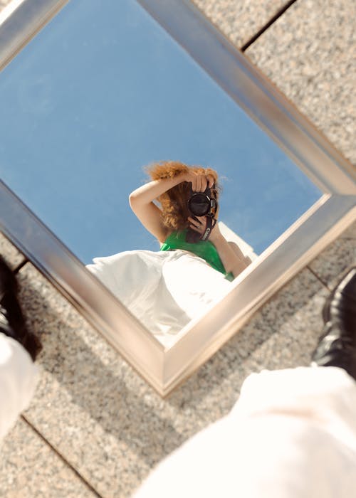 Reflection of Redhead Woman Making Mirror Selfie