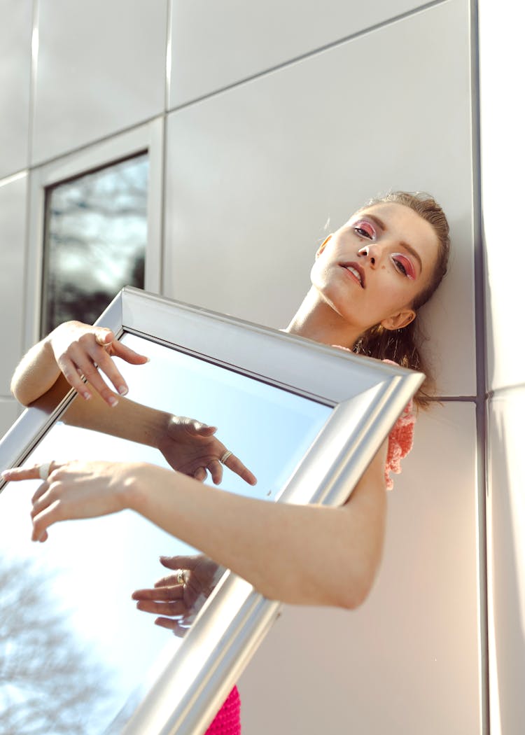 Girl Holding Mirror And Gesturing Hands Reflecting