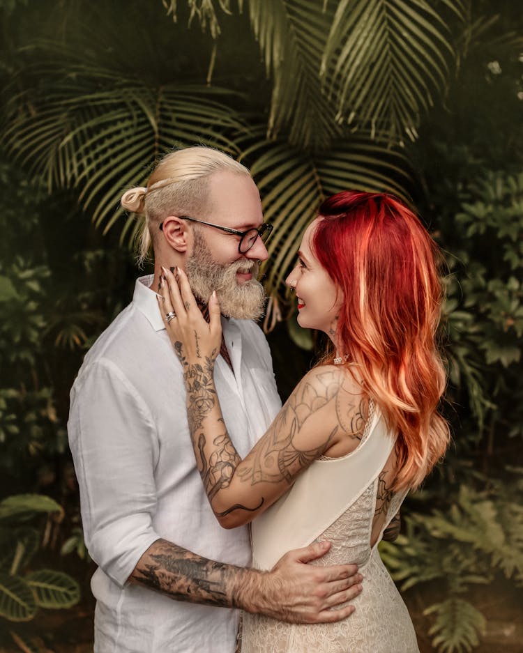 Man And Woman With Dyed Hair Standing Face To Face And Hugging 