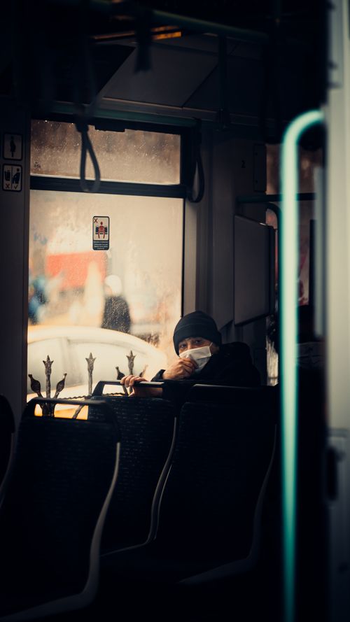 Free Person wearing a face mask inside a tram in Istanbul, capturing urban transportation vibes. Stock Photo
