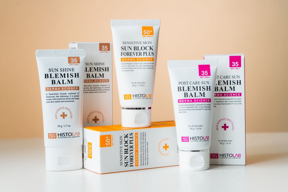 Tubes of blemish balm and sunscreen lying together
