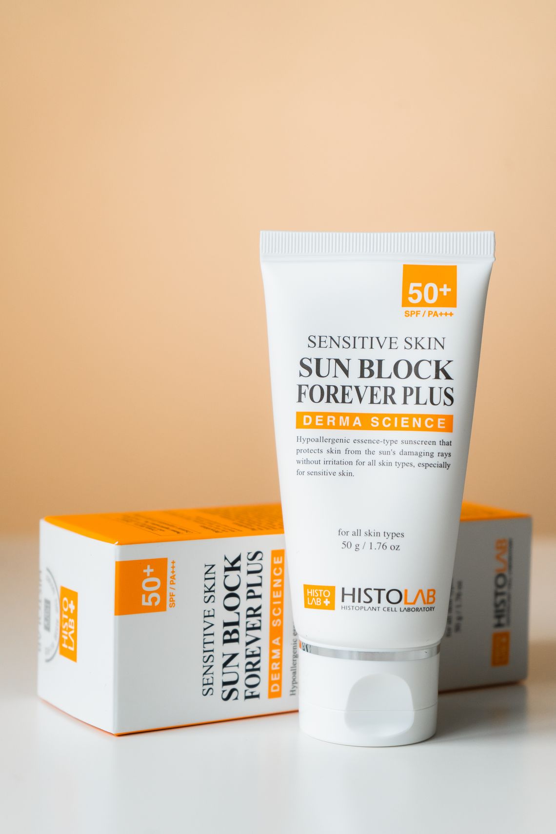 SPF sunblock and skin care products on a neutral surface