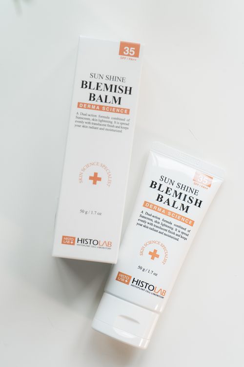 Free Minimalist flatlay of HISTOLAB Sun Shine Blemish Balm packaging on a white surface. Stock Photo
