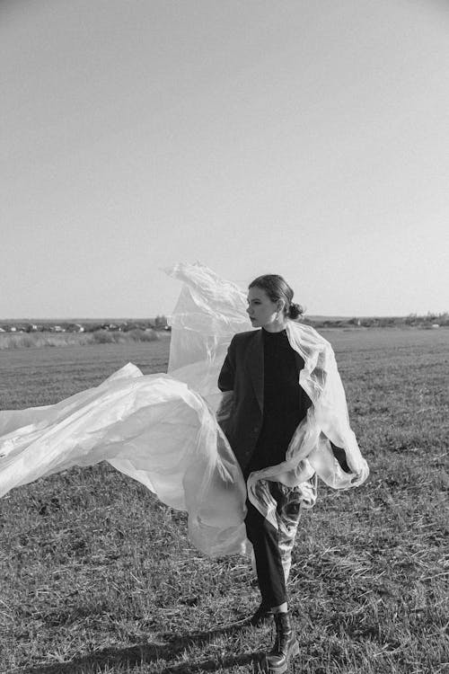 Black and White Photo of Woman in the Field