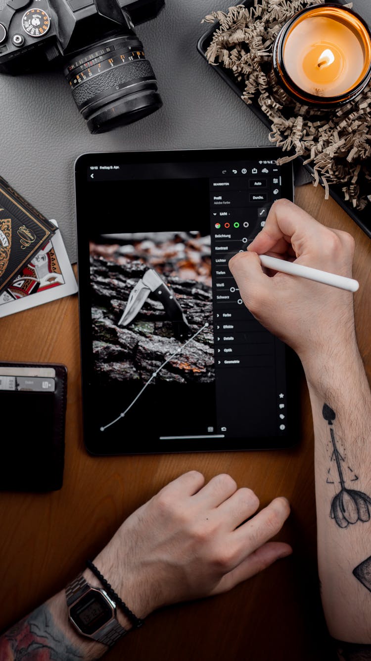 Person Editing Image On Tablet