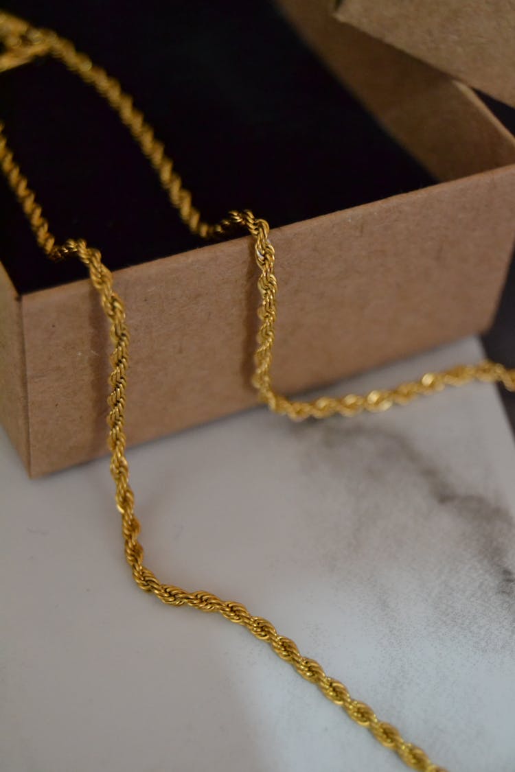 Gold Chain Necklace On Brown Box