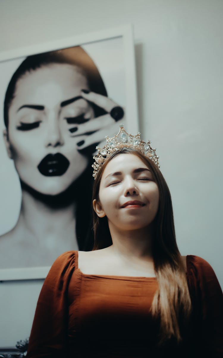 Woman In Orange Shirt Wearing Silver Crown