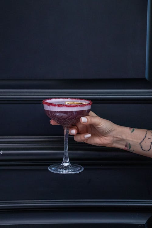 Unrecognizable Hand Holding Cocktail in Glass