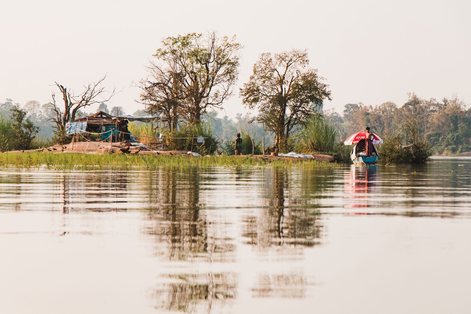 Small boat and riverside hut on the Mekong waterways near Kandal, Cambodia