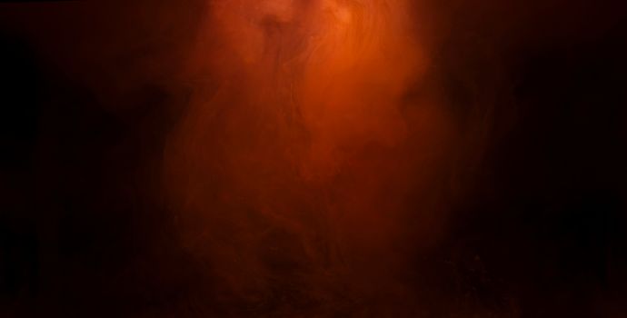A deep orange and black abstract background with a smoky and fiery texture, ideal for creative design projects.