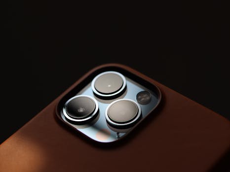Detailed close-up of modern smartphone camera lenses in a leather case.