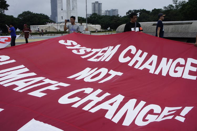 People Carrying A Banner