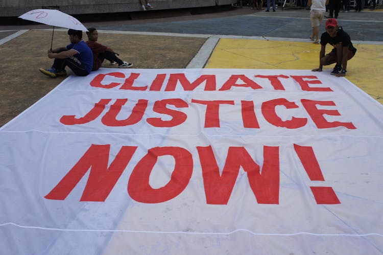 People Carrying A Banner