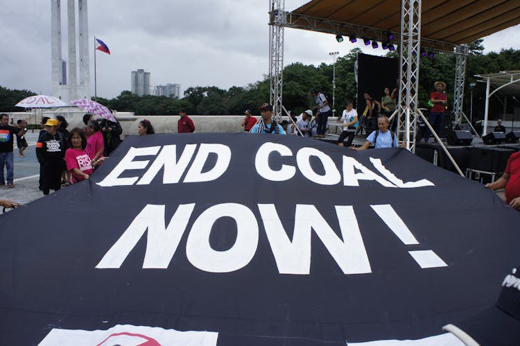 People Carrying A Banner