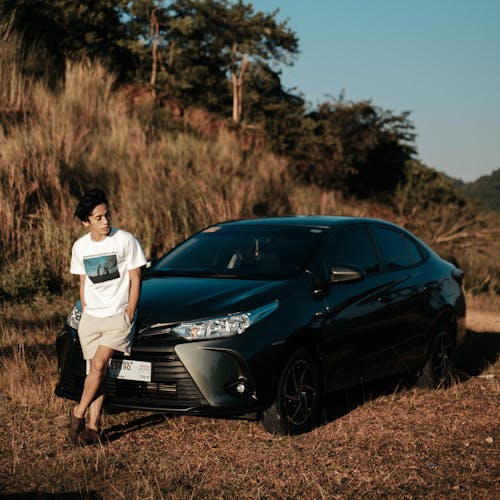 Man Leaning on a Car