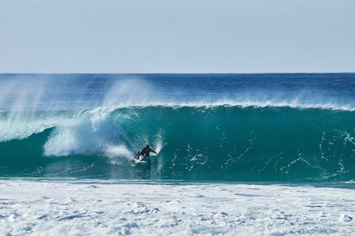 A Person Surfing on the Beach