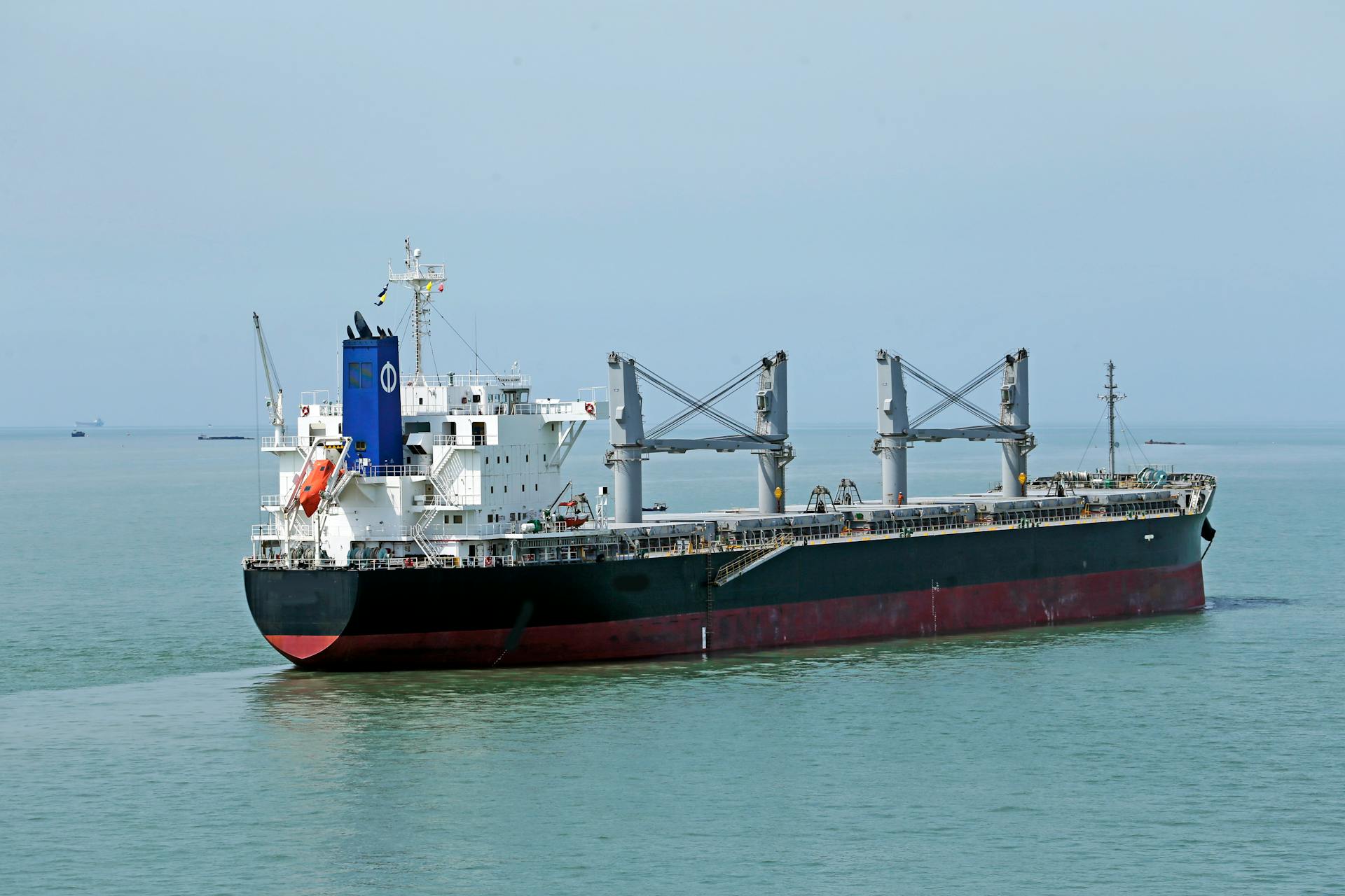 Cargo vessel navigating the calm waters of the open sea.