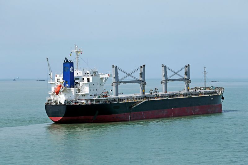 Bulk carrier vessel with deck cranes at sea
