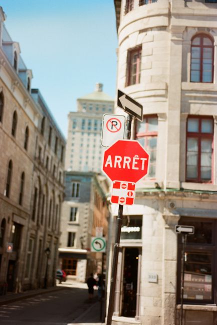 Bustling Montreal street showcasing a stop sign and iconic architecture, capturing city life.