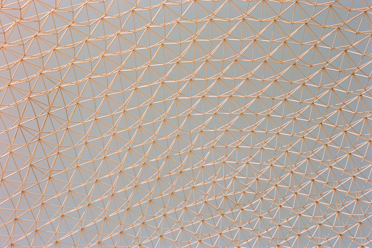 a detailed view of a geometric metal framework ceiling with triangular