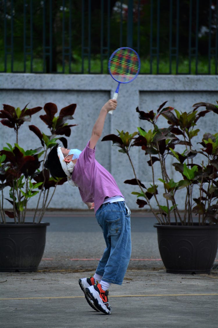 A Boy Playing Badminton