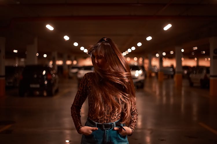 A Woman Standing In The Basement Parking 