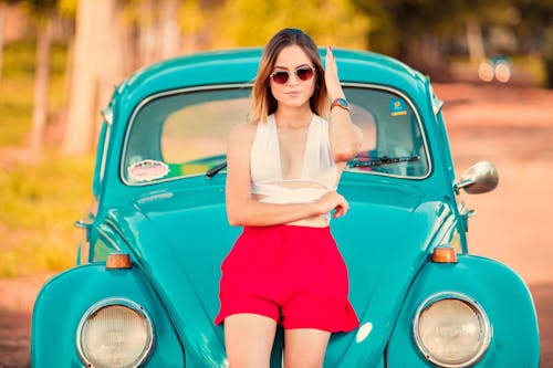 Free Woman Leaning on a Blue Car Stock Photo