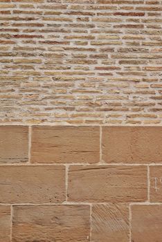 Close-up view of a textured brick wall showcasing rough patterns and earthy tones.