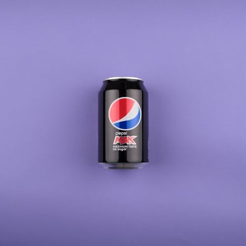 Free A Can of Soda on a Purple Surface  Stock Photo