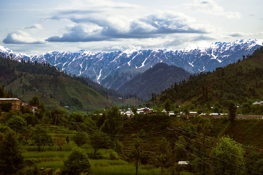Snow-capped peaks above the forested Swat valley