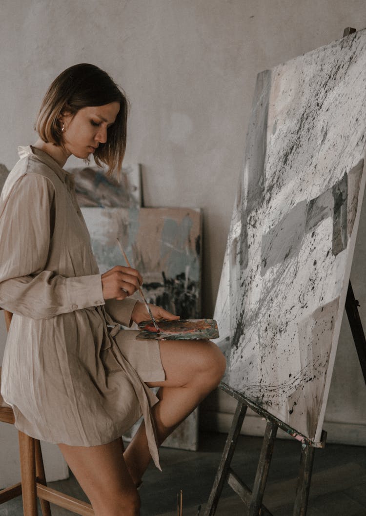 Woman Painting Abstract Piece In Workshop