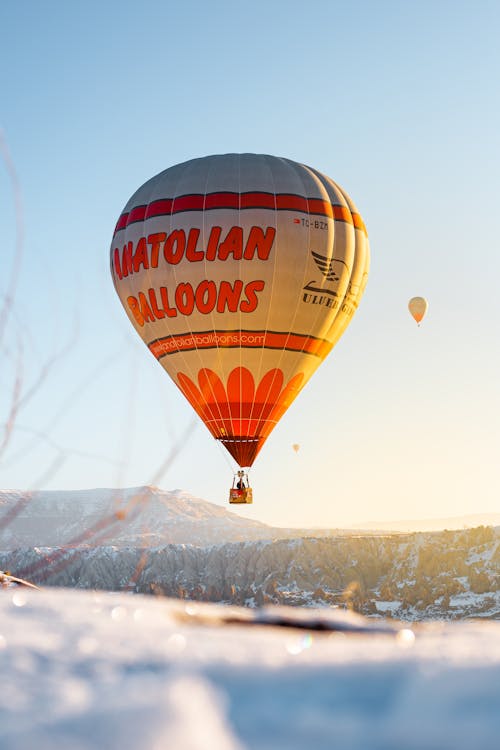 Free Balloons Flying over Snowy Landscape in Turkey Stock Photo