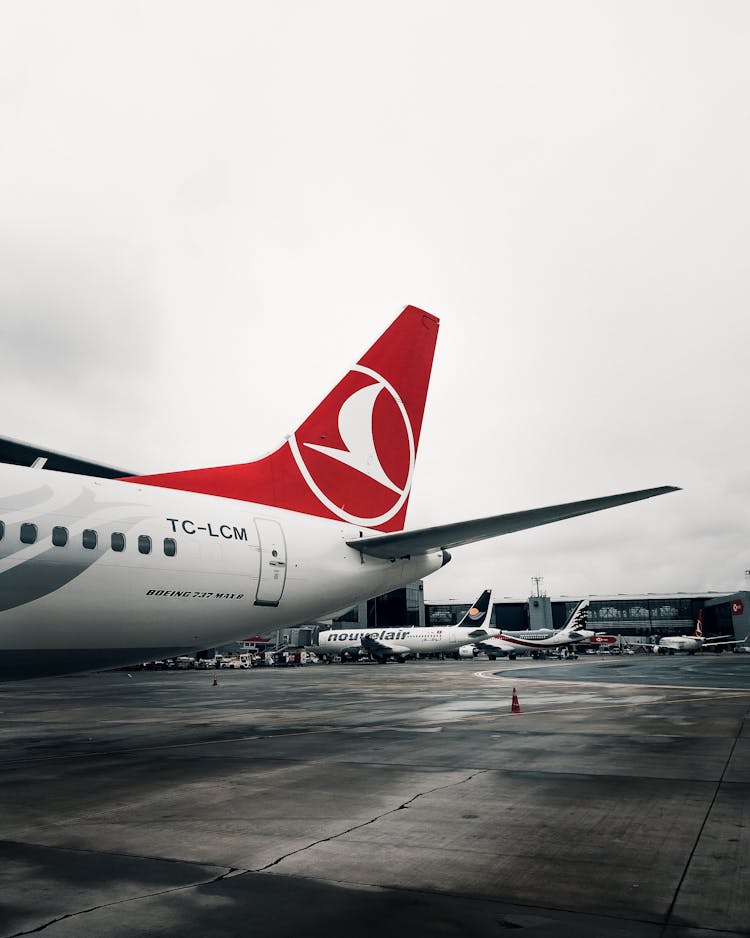 White And Red Airplane On Airport