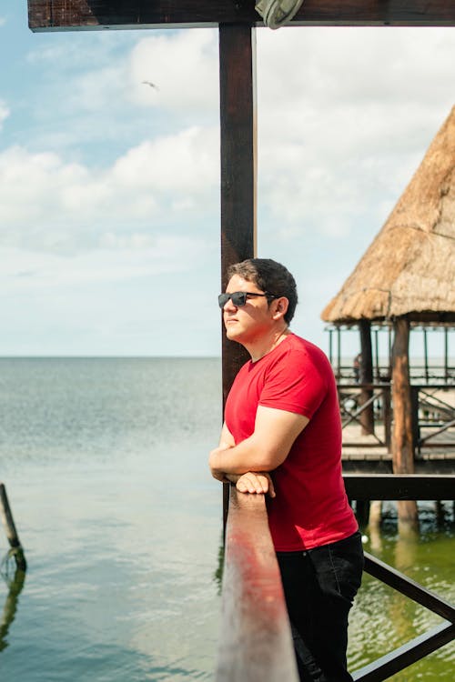 A Man in a Red Shirt Wearing Sunglasses