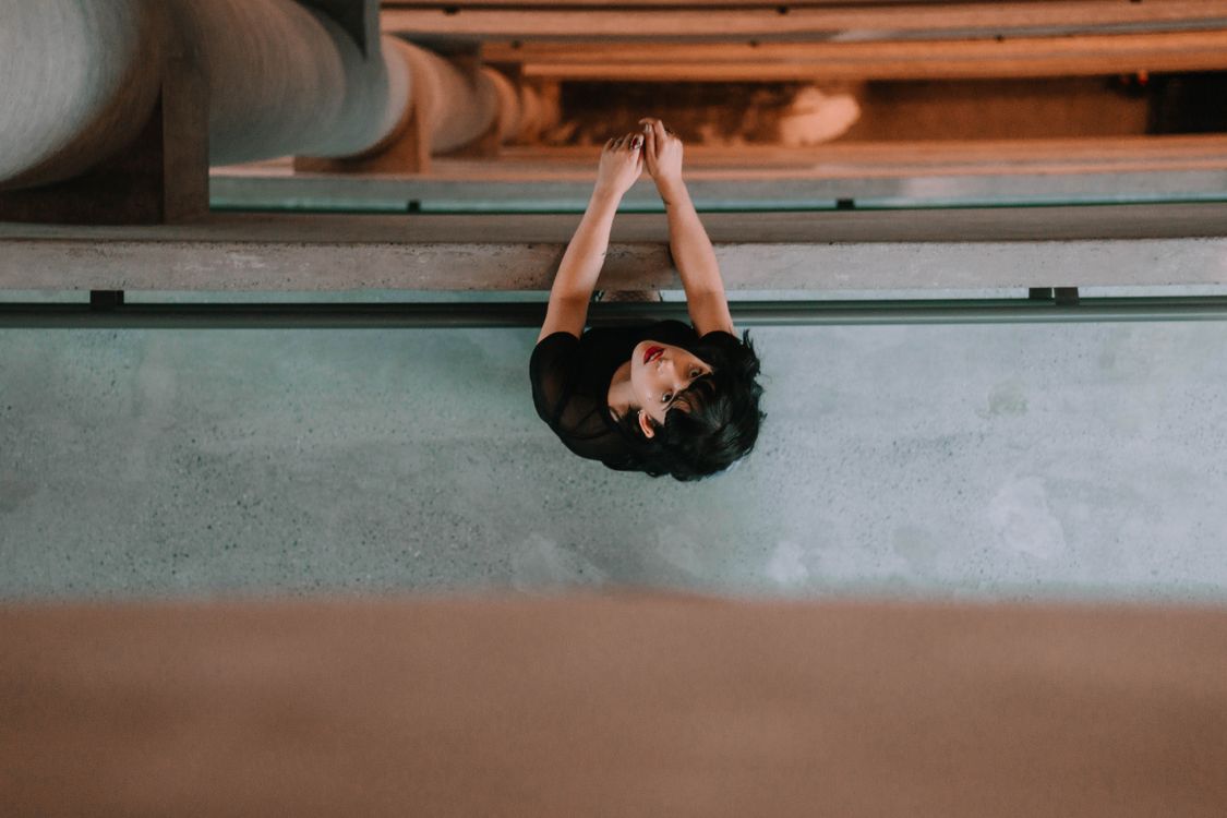Lean On Railing Top View of a Woman Standing and Leaning on the Railing · Free Stock Photo