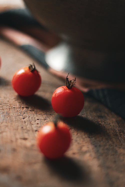 Free Red Tomatoes on Brown Wooden Surface Stock Photo