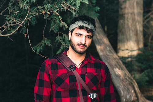 A Man Wearing a Black and Red Flannel Shirt