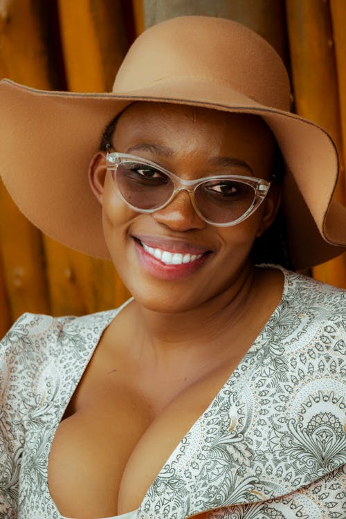 Free Woman in White Floral Lace Top Wearing Brown Sun Hat and Brown Framed Eyeglasses Stock Photo