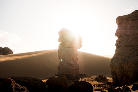 Stunning desert landscape with sunlit rock formations in Djanet, Algeria.